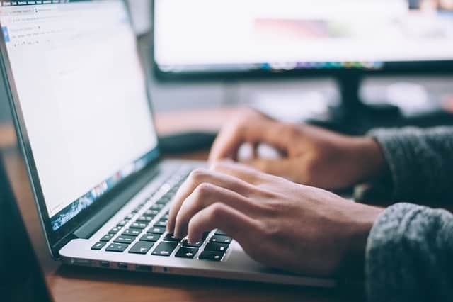 Employee using software on a laptop to ensure HR compliance