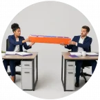 Two employees carefully trying to complete a work handoff over a big gap.
