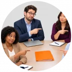 I room full of business people pointing at each other to assign accountability.