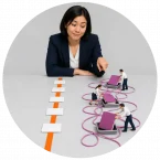A woman watching employees use workarounds instead of the designed process.
