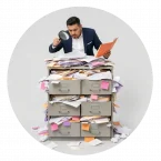 A man searching for data in a mess of file cabinets and folders.