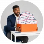 And employee with a box full of notecards showing employee feedback.