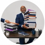 A man with a pile of binders and documents representing all the decisions a leader must make.