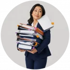 A woman overloaded with a lot of work papers that are all a priority.